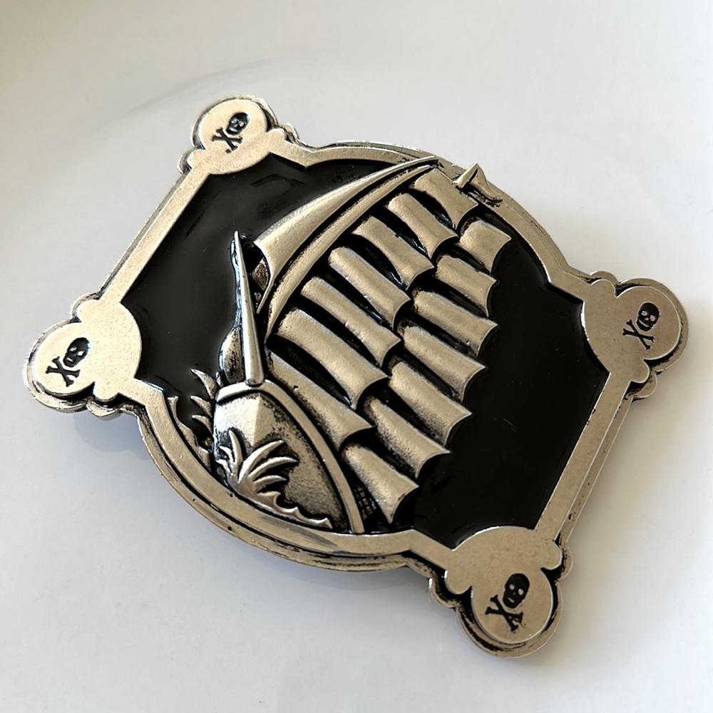 Solid metal Pirate ship with skulls belt buckle.